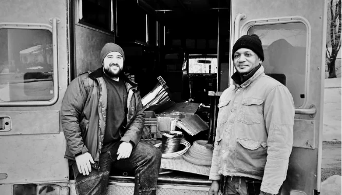 Two of the crew at the back of the loaded service van.