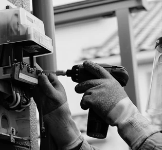 An electrician working on a residential panel.